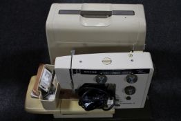 A Riccar electric sewing machine in case
