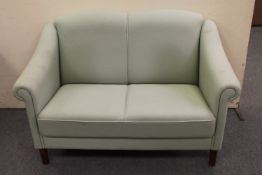 A twentieth century two seater settee upholstered in turquoise fabric