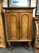 An Edwardian walnut double door side cabinet,