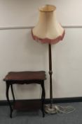 An Edwardian mahogany two tier table together with a standard lamp with shade