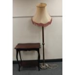 An Edwardian mahogany two tier table together with a standard lamp with shade