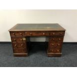 A Victorian mahogany twin pedestal desk fitted nine drawers