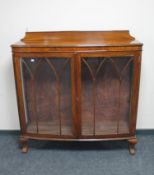 An early 20th century mahogany double door display cabinet on claw and ball feet