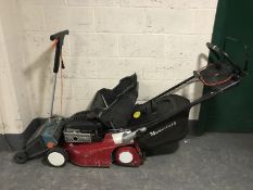 A Mountfield M3 self drive petrol lawn mower with grass box together with a Black & Decker lawn