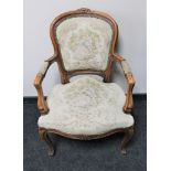 A carved continental salon armchair upholstered in a tapestry fabric