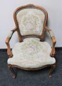 A carved continental salon armchair upholstered in a tapestry fabric