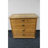An antique pine four drawer chest with brass drop handles