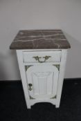 An antique painted marble topped pot cupboard