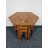 A hexagonal inlaid Moroccan occasional table