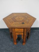 A hexagonal inlaid Moroccan occasional table
