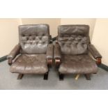 A pair of late 20th century wood framed brown buttoned leather armchairs