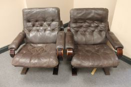 A pair of late 20th century wood framed brown buttoned leather armchairs