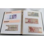An International Currency Collection album containing banknotes of the World
