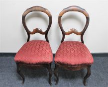 A pair of antique continental mahogany dining chairs on cabriole legs