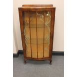 A 1930's walnut single door display cabinet