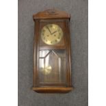 An early twentieth century oak cased wall clock with Junghans movement,