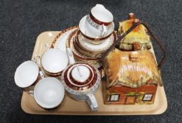 A tray containing a twenty-two piece Royal Stafford bone china tea service together with a cottage