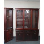 A contemporary inlaid mahogany triple door display cabinet fitted with cupboards and doors beneath