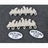 Two cast metal coats racks and two cast metal beware of the cat signs