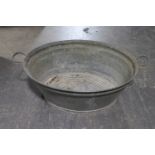 An oval galvanised twin handled wash tub