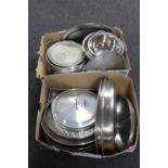 Two boxes containing stainless steel pans, lids, colanders,