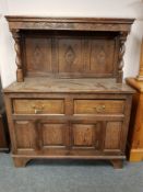 A late Victorian carved oak buffet sideboard,
