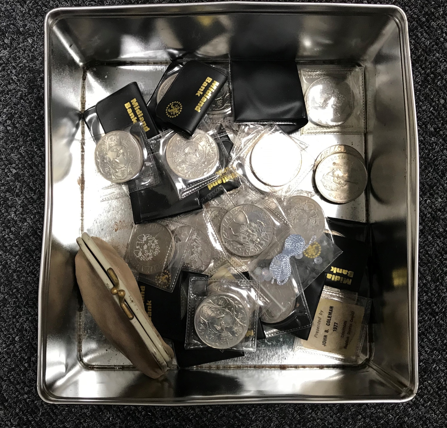 A tin containing a quantity of British Crowns,