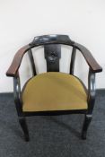 An early 20th century stained oak armchair