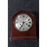 An antique mahogany bracket block on brass feet with silvered dial,