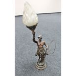 A late 19th century spelter figural table lamp modelled as a blacksmith holding torch aloft