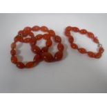 An early twentieth century amber coloured beaded necklace and bracelet.