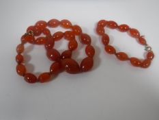An early twentieth century amber coloured beaded necklace and bracelet.