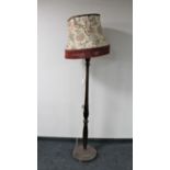 An antique mahogany standard lamp with shade