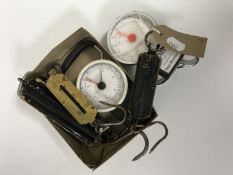 A box of four vintage pocket scales and two luggage scales