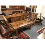 An Indonesian hardwood two seater bench,