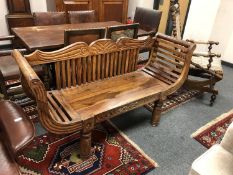 An Indonesian hardwood two seater bench,