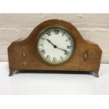 A late 19th century inlaid mahogany mantel clock on brass feet