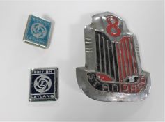 A large vintage Standard 8 car badge and two British Leyland badges