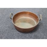 An antique copper twin handled cooking pot