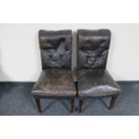 A pair of antique dining chairs in buttoned leather upholstery