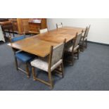 An early 20th century continental oak pull out dining table together with six chairs