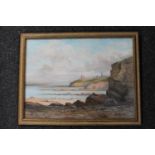 A 20th century gilt framed oil depicting Tynemouth Priory and coastline,