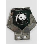 A World Wildlife Fund vintage car badge depicting a panda