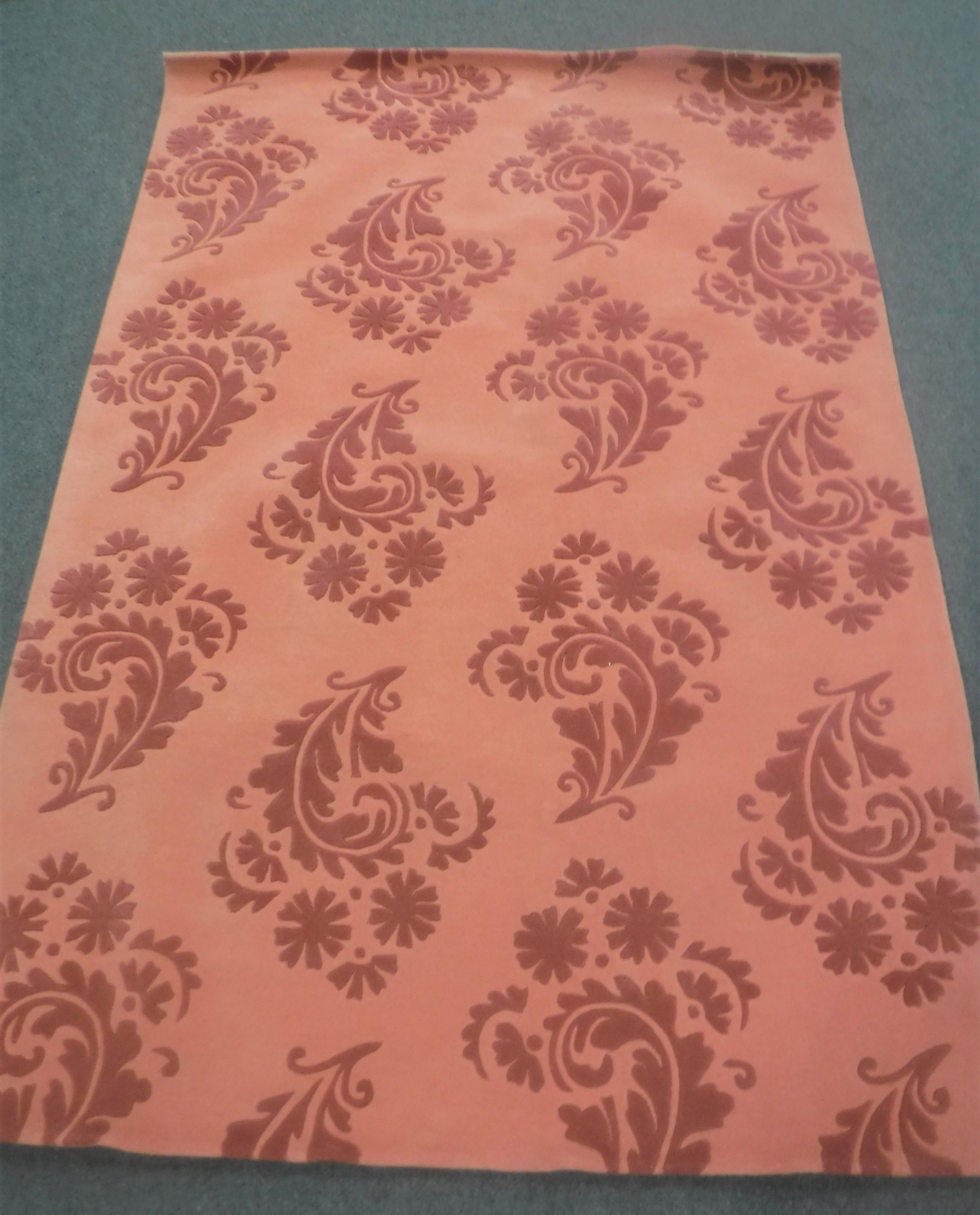A hand-knotted rug on pink ground,