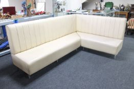 A corner seat upholstered in a cream leather