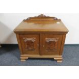 A 20th century continental oak double door cabinet with walnut panelled doors