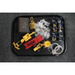 A tray of Robertson's golly figures and pin badges, die cast Matchbox bulldozer,