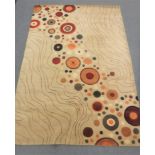 A hand-knotted rug with swirl design on beige ground,