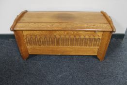 A carved oak blanket box