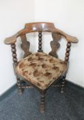 An early 20th century oak corner chair on bobbin legs